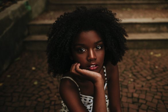 african american girl sitting on pavement