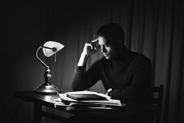 contemplative man reading book in classy home office
