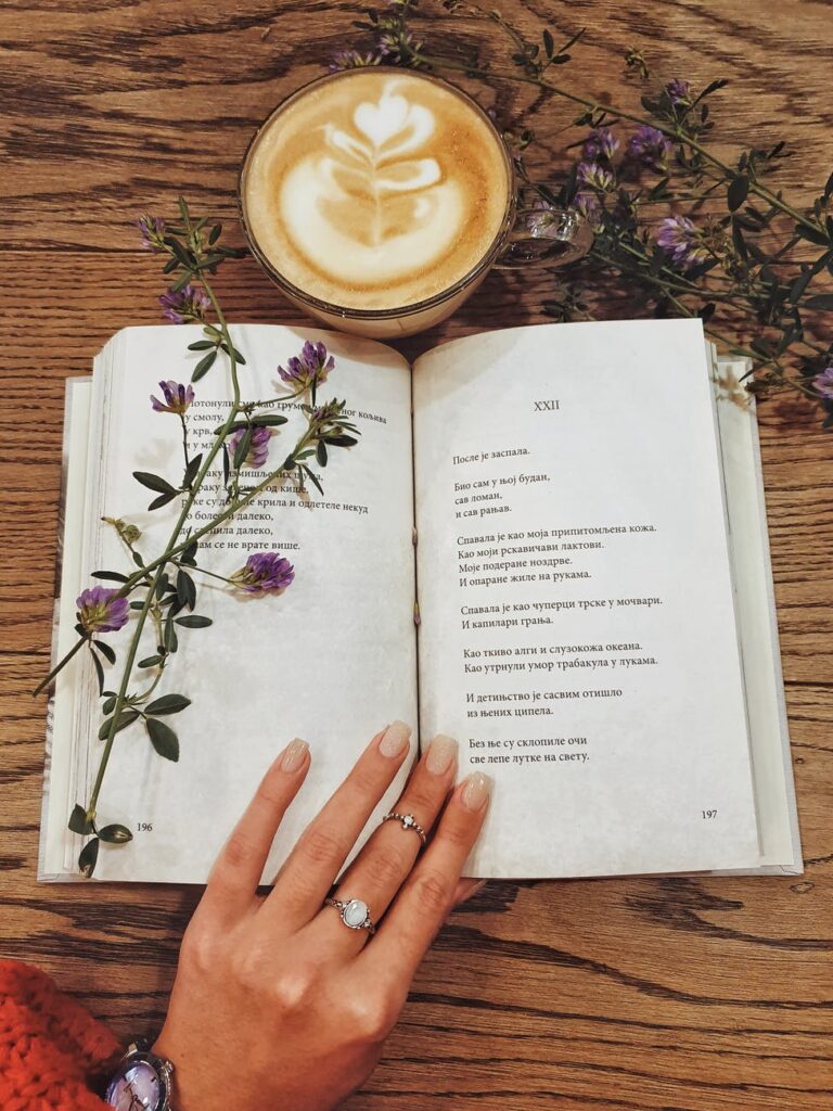 beverage in cup next to open book