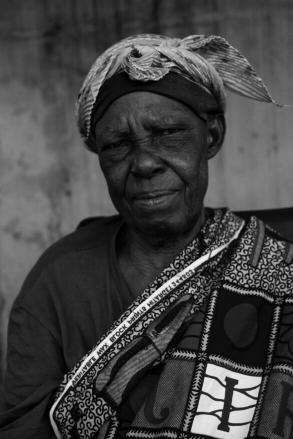 grayscale photo of an elderly woman with bandana