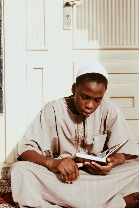 black man reading islamic sacred book